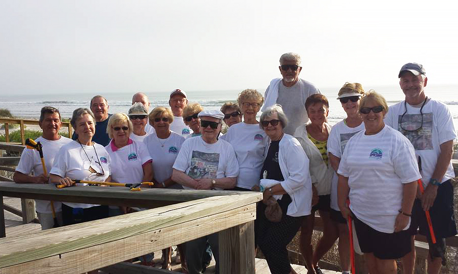 Group of The Harbor Isles Beach Sweepers Adopt a Shore Program people after a beach clean up