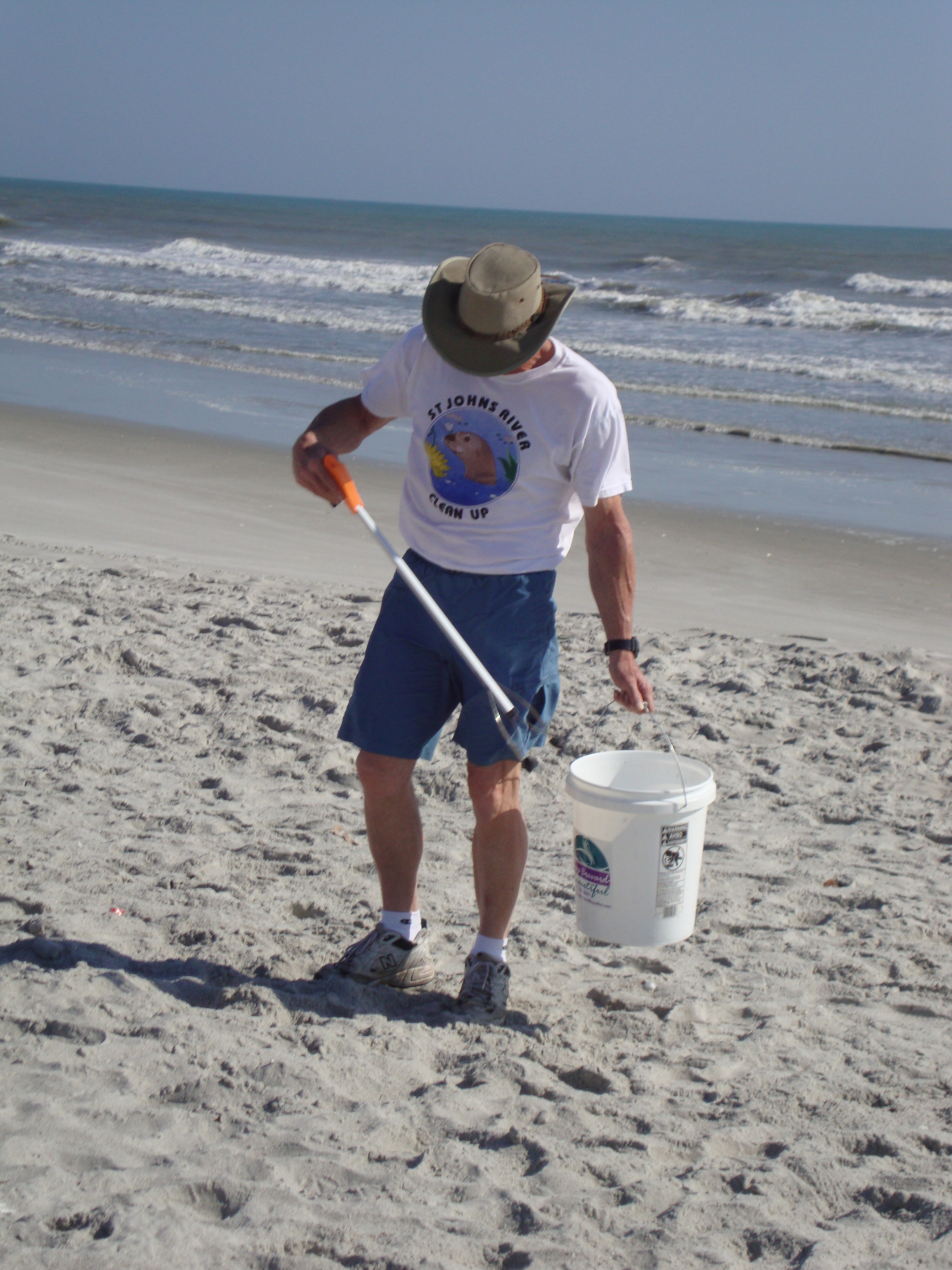 Jim Kriewalt, KBB Spoil Island & Invasive Plant Manager picking up trash at the beach.